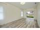 Bedroom with wood-look floors, sliding glass doors to the lanai, and neutral decor at 14455 Silver Lakes Cir, Port Charlotte, FL 33953