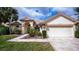Charming single-story home with a manicured lawn, two-car garage, and elegant architecture at 14455 Silver Lakes Cir, Port Charlotte, FL 33953