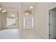 Bright foyer featuring tile floors, chandelier, and arched transom window at 14455 Silver Lakes Cir, Port Charlotte, FL 33953