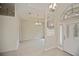 Inviting foyer with tile flooring, high ceilings, chandelier, and arched doorway at 14455 Silver Lakes Cir, Port Charlotte, FL 33953