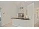 Open concept kitchen with a breakfast bar, modern appliances, and tile flooring throughout at 14455 Silver Lakes Cir, Port Charlotte, FL 33953