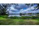 Scenic view of a tranquil lake surrounded by lush landscaping and homes at 14455 Silver Lakes Cir, Port Charlotte, FL 33953
