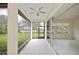 Inviting lanai featuring tiled floors, a ceiling fan, and a tranquil lake view at 14455 Silver Lakes Cir, Port Charlotte, FL 33953