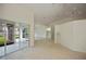 Expansive living area with sliding glass doors offering views of the lanai and lake at 14455 Silver Lakes Cir, Port Charlotte, FL 33953