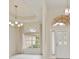 Bright living room featuring a chandelier, large windows, and an arched entryway at 14455 Silver Lakes Cir, Port Charlotte, FL 33953
