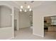 Open-concept living area with kitchen view, modern lighting, and neutral wall color at 14455 Silver Lakes Cir, Port Charlotte, FL 33953