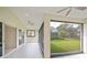 Covered patio with screened enclosure offering picturesque views of the landscaped backyard at 14455 Silver Lakes Cir, Port Charlotte, FL 33953