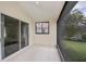 Covered patio featuring tiled flooring, a screen, and views of the landscaped yard at 14455 Silver Lakes Cir, Port Charlotte, FL 33953