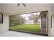 Screened patio showcasing a serene lake view and lush green landscaping at 14455 Silver Lakes Cir, Port Charlotte, FL 33953