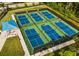 Aerial view of multiple pickleball courts with new nets and green surroundings at 14455 Silver Lakes Cir, Port Charlotte, FL 33953