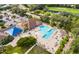 Aerial view of community pool with ample seating, shaded area, and lush landscaping at 14455 Silver Lakes Cir, Port Charlotte, FL 33953