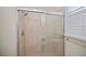 Modern shower with glass doors, light tile surround, and brushed silver fixtures at 14455 Silver Lakes Cir, Port Charlotte, FL 33953