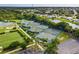 Well-maintained tennis courts surrounded by lush greenery, offering a great recreational space at 14455 Silver Lakes Cir, Port Charlotte, FL 33953