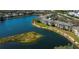 Beautiful aerial view of the condo community, featuring a scenic lake and well-maintained landscaping at 19335 Water Oak Dr # 202, Port Charlotte, FL 33948