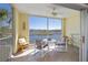 Screened-in balcony with tile flooring, ceiling fan, and scenic water views at 19335 Water Oak Dr # 202, Port Charlotte, FL 33948
