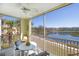 Screened-in balcony offering picturesque water views and comfortable seating at 19335 Water Oak Dr # 202, Port Charlotte, FL 33948