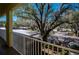 A serene balcony view overlooks the parking area and mature trees, offering a peaceful outdoor space at 19335 Water Oak Dr # 202, Port Charlotte, FL 33948