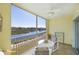 Enjoy serene water views from this screened-in balcony with a ceiling fan at 19335 Water Oak Dr # 202, Port Charlotte, FL 33948
