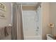 Bright bathroom features a shower over tub with tile surround and neutral color palette at 19335 Water Oak Dr # 202, Port Charlotte, FL 33948
