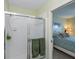 Ensuite bathroom with glass shower and access to the bright, inviting bedroom at 19335 Water Oak Dr # 202, Port Charlotte, FL 33948