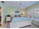 Charming bedroom featuring plantation shutters, a ceiling fan, and an ensuite bath at 19335 Water Oak Dr # 202, Port Charlotte, FL 33948
