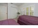 Bedroom with two twin beds and bright shutters offering privacy and natural light at 19335 Water Oak Dr # 202, Port Charlotte, FL 33948