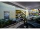 Exterior view of condo building with car port and covered stairwell entrance at 19335 Water Oak Dr # 202, Port Charlotte, FL 33948