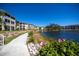 Condominium exteriors along the water feature well maintained landscaping at 19335 Water Oak Dr # 202, Port Charlotte, FL 33948