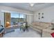 Bright living room with sliding glass doors leading to a screened patio and tranquil water views at 19335 Water Oak Dr # 202, Port Charlotte, FL 33948