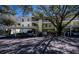 Condo parking area featuring covered parking, beautiful trees, and well maintained landscaping at 19335 Water Oak Dr # 202, Port Charlotte, FL 33948