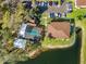 Aerial community view of a community pool and surrounding lush landscaping near a tranquil lake at 19505 Quesada Ave # Ee204, Port Charlotte, FL 33948
