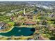 Aerial shot showcasing the condo community with mature trees, lake, and serene surroundings at 19505 Quesada Ave # Ee204, Port Charlotte, FL 33948