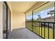 Inviting screened balcony featuring views of lush greenery and swaying palm trees, perfect for relaxation at 19505 Quesada Ave # Ee204, Port Charlotte, FL 33948