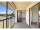 Balcony with sliding glass door access, offering a glimpse of the interior and a view of the parking lot at 19505 Quesada Ave # Ee204, Port Charlotte, FL 33948