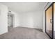 Spacious carpeted bedroom with a sliding glass door and ample natural light, perfect for relaxation at 19505 Quesada Ave # Ee204, Port Charlotte, FL 33948