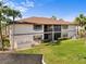 Aerial of condo building with balconies overlooking green lawns, and well-maintained landscaping at 19505 Quesada Ave # Ee204, Port Charlotte, FL 33948