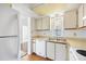 Well-lit kitchen featuring white appliances and cabinets offering ample storage and functionality at 19505 Quesada Ave # Ee204, Port Charlotte, FL 33948