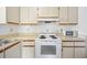 Bright kitchen featuring white appliances, ample cabinet space, and a clean, functional design at 19505 Quesada Ave # Ee204, Port Charlotte, FL 33948