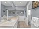 Well-lit bathroom with dual sinks and vanity featuring white cabinets and gray walls with picture frames at 237 Venezia Ct, Punta Gorda, FL 33950