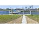 Scenic waterfront view with private boat dock and lush green lawn leading to canal at 237 Venezia Ct, Punta Gorda, FL 33950