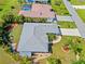 Gorgeous aerial view displaying the manicured lawn, mature trees, and meticulously designed landscape at 27191 Tierra Del Fuego Cir, Punta Gorda, FL 33983