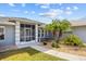 Charming front entrance with a screened entryway, a decorative fountain, and beautiful landscaping in a tranquil setting at 27191 Tierra Del Fuego Cir, Punta Gorda, FL 33983