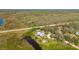 Wide aerial view of the home displaying waterfront property surrounded by greenery at 29175 River Dr, Punta Gorda, FL 33982