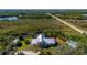 Scenic aerial shot of the house showcasing its unique architecture and serene surroundings at 29175 River Dr, Punta Gorda, FL 33982
