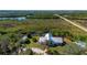 Quaint home on expansive property offering a tranquil retreat surrounded by lush greenery and water features at 29175 River Dr, Punta Gorda, FL 33982