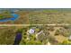 Panoramic aerial shot displaying water access and verdant landscape surrounding the house at 29175 River Dr, Punta Gorda, FL 33982