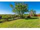 Home backyard with views of beautiful landscaping and pond at 29175 River Dr, Punta Gorda, FL 33982