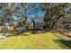 Expansive backyard features mature trees, shed, metal containers, and perimeter fencing at 29175 River Dr, Punta Gorda, FL 33982