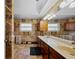 Spacious bathroom features stone tile walls, dual sinks with dark wood cabinets, and a large mirror reflecting natural light at 29175 River Dr, Punta Gorda, FL 33982