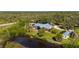 Beautiful house with a metal roof and a serene pond view surrounded by lush greenery at 29175 River Dr, Punta Gorda, FL 33982